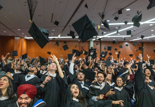 Graduates throwing caps in the air